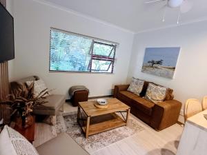 a living room with a couch and a table at GreenPeace in Stellenbosch