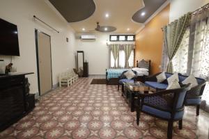 a living room with a couch and a tv at Trisha Heritage in Dibrugarh