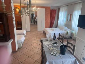 a living room with two beds and a table at Osteria del Cavaliere B&B e Maneggio in Sacrofano