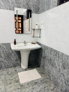 a bathroom with a white sink and a mirror at The Green Escape in Miriswatta +59 photos
