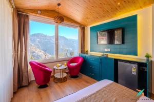 a room with two pink chairs and a window at Zostel Homes Mussoorie, Mall Road in Mussoorie