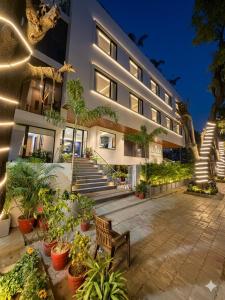 a building with a bunch of plants in front of it at Nirvana Nest - Corporate Stay, Gomti Nagar, Lucknow in Lucknow