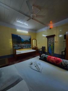 a bedroom with a large bed with a ceiling at Aranya Darshan in Lataguri