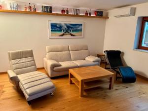 a living room with a couch and a table and chairs at Dům pod horami - Beskydy in Frýdlant nad Ostravicí