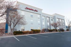 a large white building with a pharmacy sign on it at Hampton Inn Richfield in Richfield