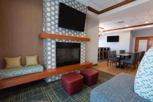 a living room with a fireplace and a flat screen tv at Hampton Inn Richfield in Richfield