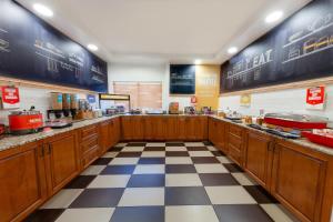a restaurant kitchen with wooden cabinets and a checkered floor at Hampton Inn Richfield in Richfield