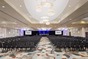 a large room with chairs and a stage in it at Hilton Albany in Albany