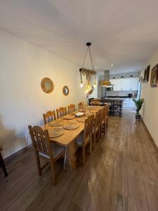 a dining room with a long table and chairs at Los Abuelos Carreros in Consuegra +9 photos