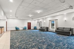 a large room with couches and a table and chairs at Hampton Inn & Suites Detroit-Canton in Canton +32 photos