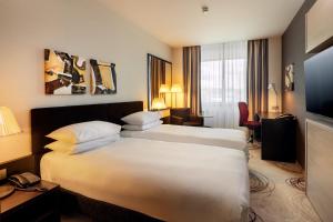 a hotel room with a large bed and a television at DoubleTree By Hilton Košice in Košice +81 photos