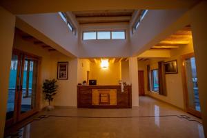 a living room with a large room with windows at Royal Soma Resort in Stak