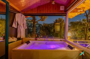 a large bath tub in a room with a window at Zostel Homes Mussoorie, Mall Road in Mussoorie