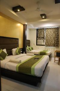a hotel room with two beds and a window at Hotel Lav Kush Deluxe 2 Min Walk From New Delhi Railway Station in New Delhi +157 photos