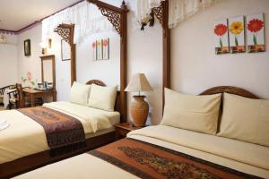 a hotel room with two beds and a table at Ban Ao Thong in Trang +60 photos