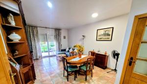 a living room with a table and a couch at Can Carbó in Pals