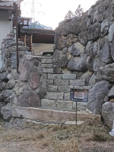 a stone wall with a sign in front of it at Fewo zum schwarzen Hirsch in Dalaas