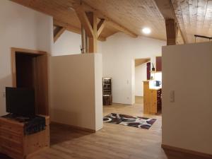 a living room with a flat screen tv on a table at Fewo zum schwarzen Hirsch in Dalaas +11 photos