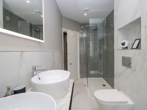 a bathroom with a sink and a toilet and a shower at Beckmead in Windermere +36 photos