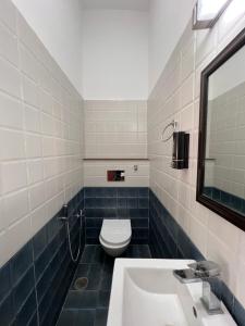 a bathroom with a toilet and a sink at The Bougainvillea Retreat in Dehradun