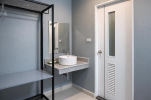 a bathroom with a sink and a mirror at My Friends Hotel in Trang +34 photos