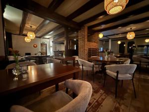 a restaurant with tables and chairs in a room at Hotel de Koningsherberg in Anloo