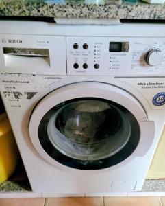 a white washing machine sitting in a kitchen at Can Carbó in Pals