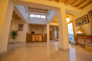 a large room with columns and a counter in a building at Royal Soma Resort in Stak