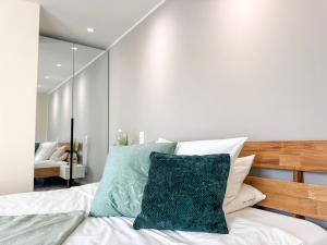 a bedroom with a bed with a mirror on the wall at Kreilingshöfchen Apartments in Bad Vilbel