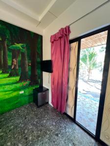 a room with a red curtain and a window at Dutch Guest House Studio in Siquijor