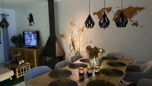a living room with a table with chairs and a television at Manilva Beach Casa de Pedro in Manilva