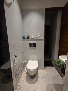 a bathroom with a toilet and a sink at Yogqala Homestay 04 in Jaipur