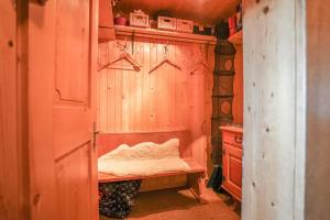 a room with a wooden wall with a bench at Chalet Mungg in Bettmeralp +11 photos