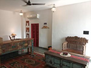 a living room with a bed and a red door at Paddy's Loft The Lake B&B in Udaipur