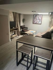 a living room with a table and chairs and a couch at Les logis du Landron in Plessé