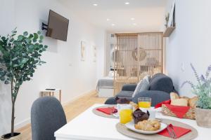 a living room with a table with food on it at Valencia Marina Apartment near Beach & City of Arts in Valencia