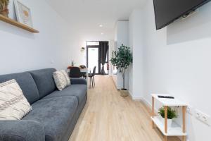 a living room with a couch and a table at Valencia Marina Apartment near Beach & City of Arts in Valencia