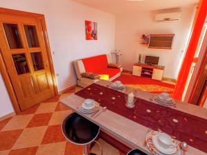 a living room with a table and a couch at Rustic Cottage with Pool in Dramalj
