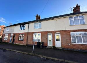 a red brick house with white doors and windows at Spacious 3-Bed Terrace, Great Links in Stowmarket