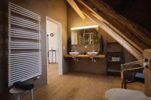 a bathroom with two sinks in a attic at Niesen Loft in Spiez +33 photos