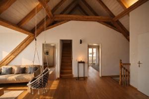 a living room with a couch and a swing at Niesen Loft in Spiez