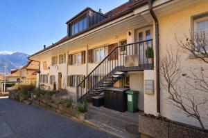 a building with a staircase on the side of it at Niesen Loft in Spiez