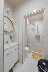 a bathroom with a toilet and a sink and a shower at ROYAL ROOMS*** in Ljubljana