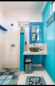 a blue bathroom with a sink and a mirror at Isin Gumi Homestay in Amed +24 photos
