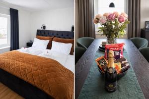 a bedroom with a bed and a table with a bottle of champagne at KB - Villa sentrum Leknes in Vestvågøya
