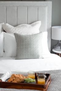a tray of food on top of a bed at Central Cheltenham Luxury Apartment – Edmonstone House in Cheltenham