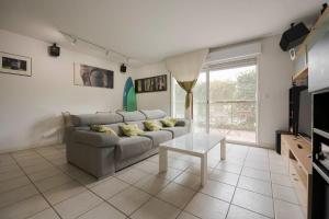 a living room with a couch and a table at Villas del Empereur in Hendaye