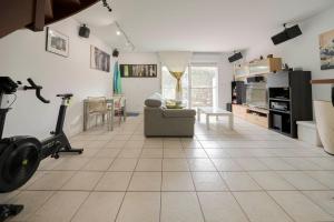a living room with a treadmill and a gym at Villas del Empereur in Hendaye