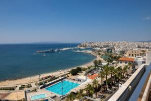 a view of a beach and a swimming pool at Cavo D' Oro in Piraeus