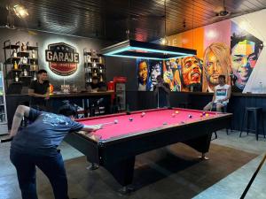 a man playing a game of pool in a bar at Melvo's Homestay in Puerto Princesa City